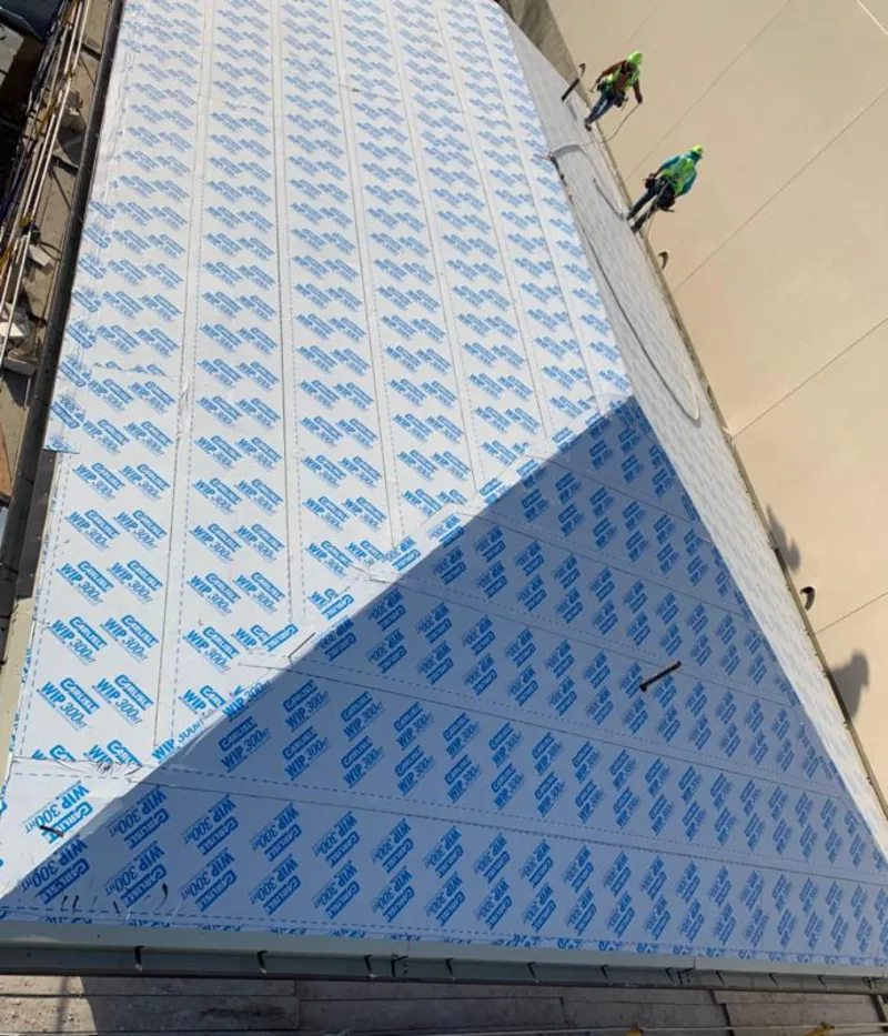 Professional roofers installing underlayment on a metal roof in Elk Grove